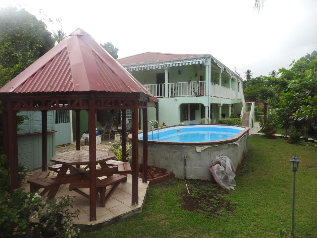 a house with a swimming pool and a gazebo at Vacances Antilles in La Trinité