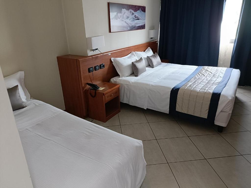 Postel nebo postele na pokoji v ubytování Green Hotel Ninfa