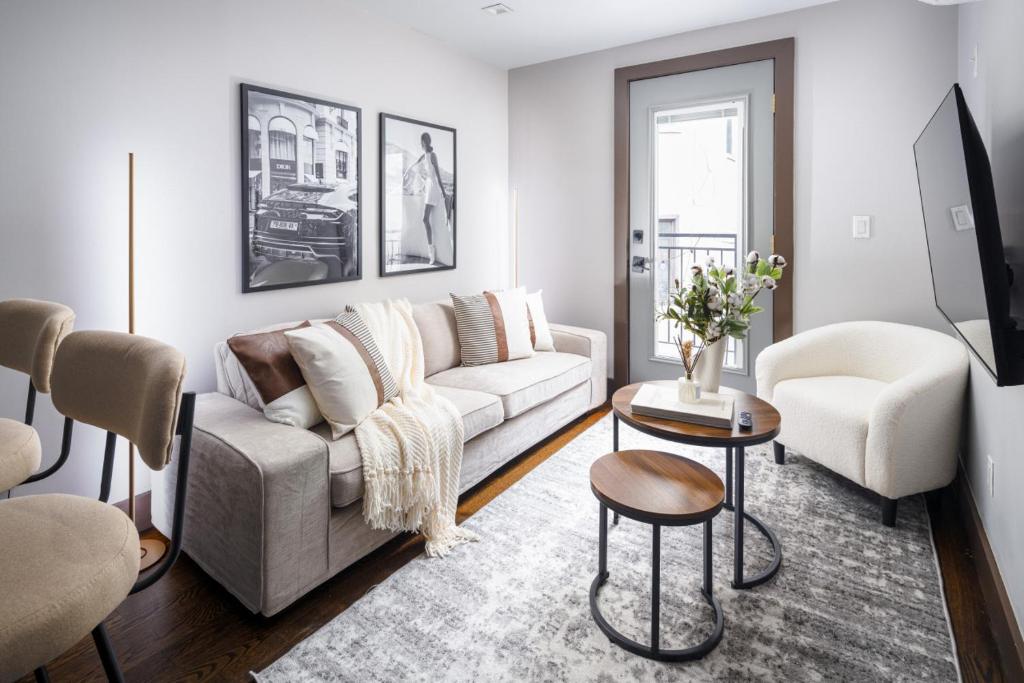 a living room with a couch and a table and chairs at Modern Luxury 3BD and 2BA in the Heart of East Village in New York