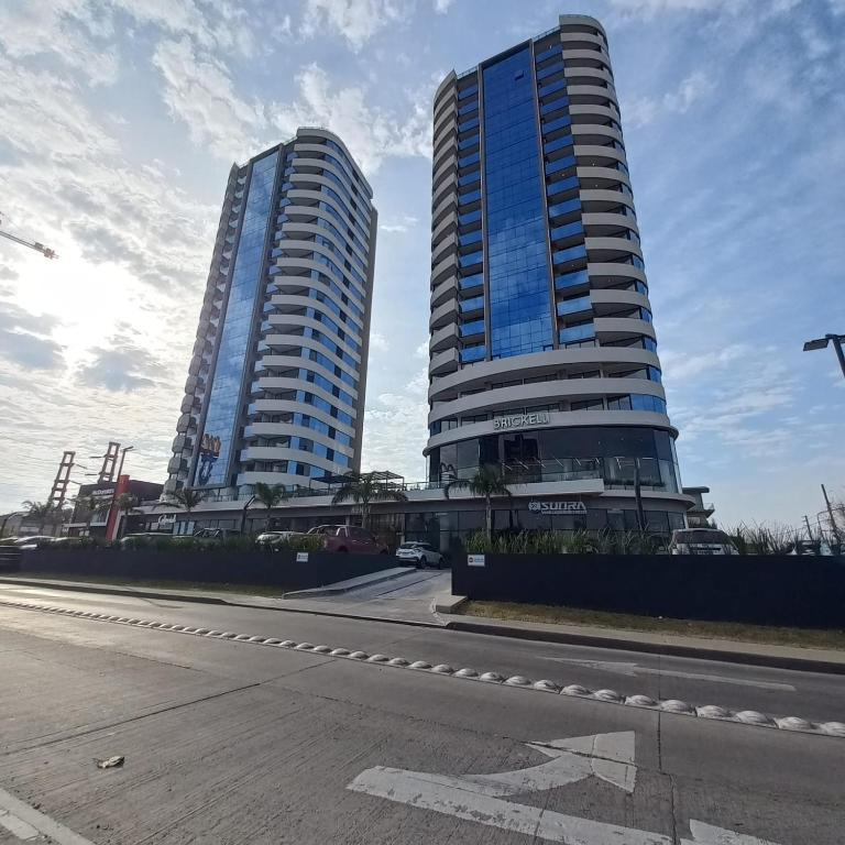 two tall buildings on the side of a street at Torres Brickell Departamento -MALVAN- 1A in Tigre