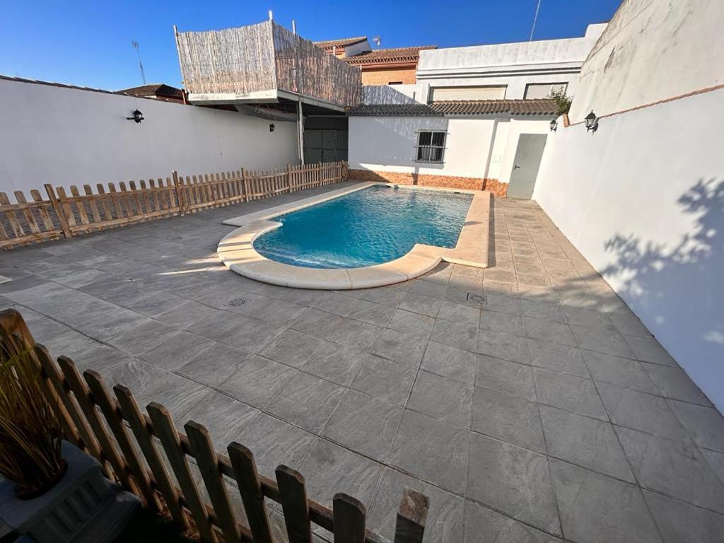 a swimming pool in the middle of a patio at Chalet Empul El Béjar in Chiclana de la Frontera