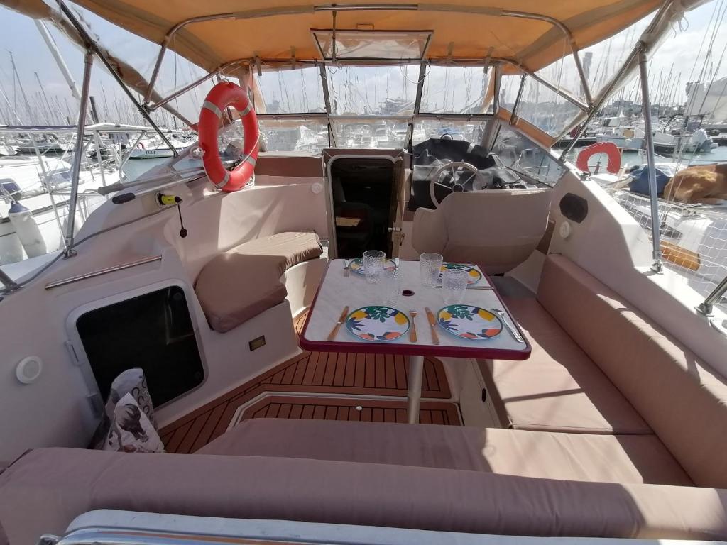 a table in the back of a boat with plates of food at Dormir sur un yacht insolite in La Rochelle