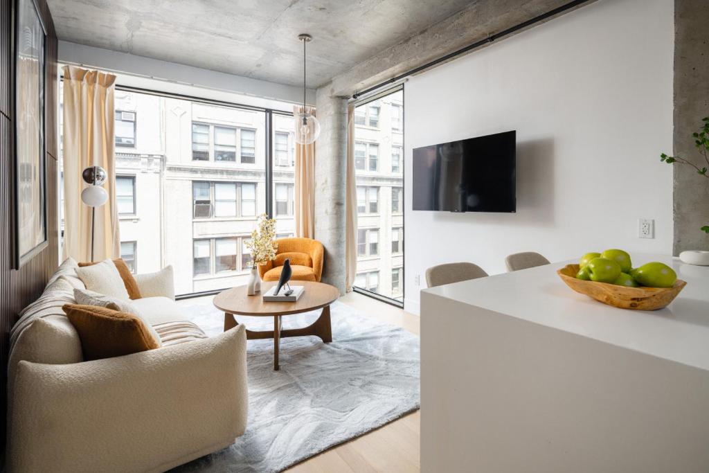 a living room with a couch and a table at Perfectly located 2BD Penthouse in Chelsea in New York