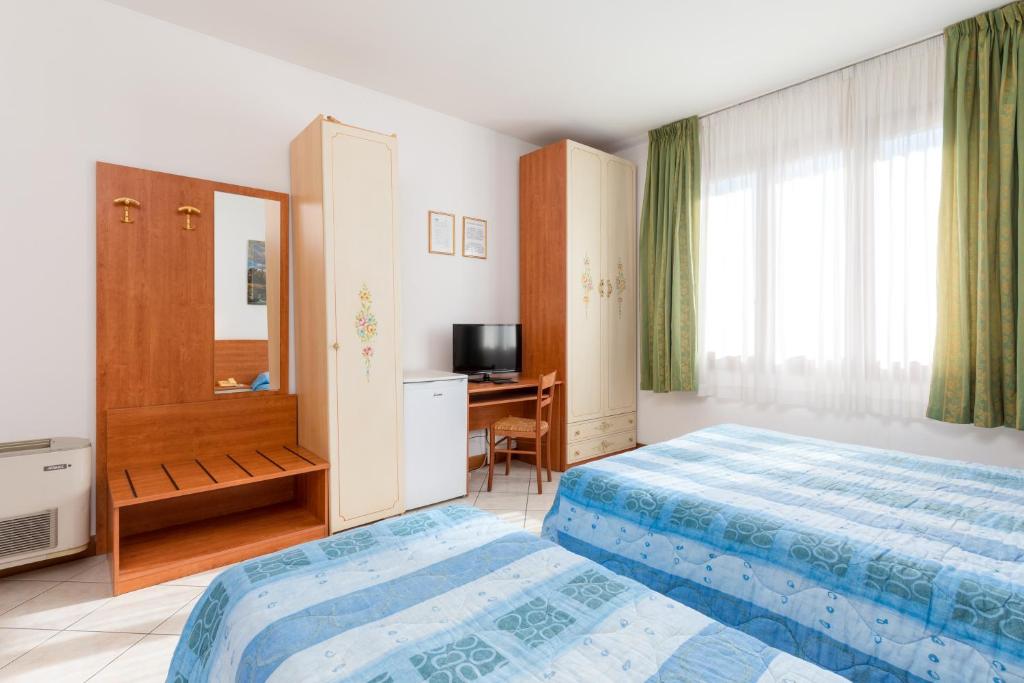 Posteľ alebo postele v izbe v ubytovaní Hotel New Aurora Venice