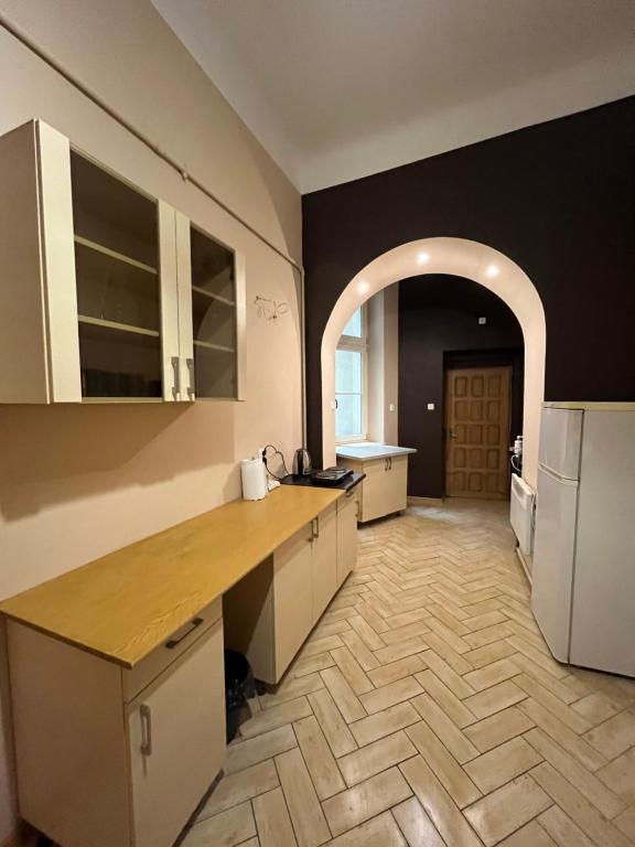 a large kitchen with a counter and an archway at Old Town Rooms Wielopole in Krakow