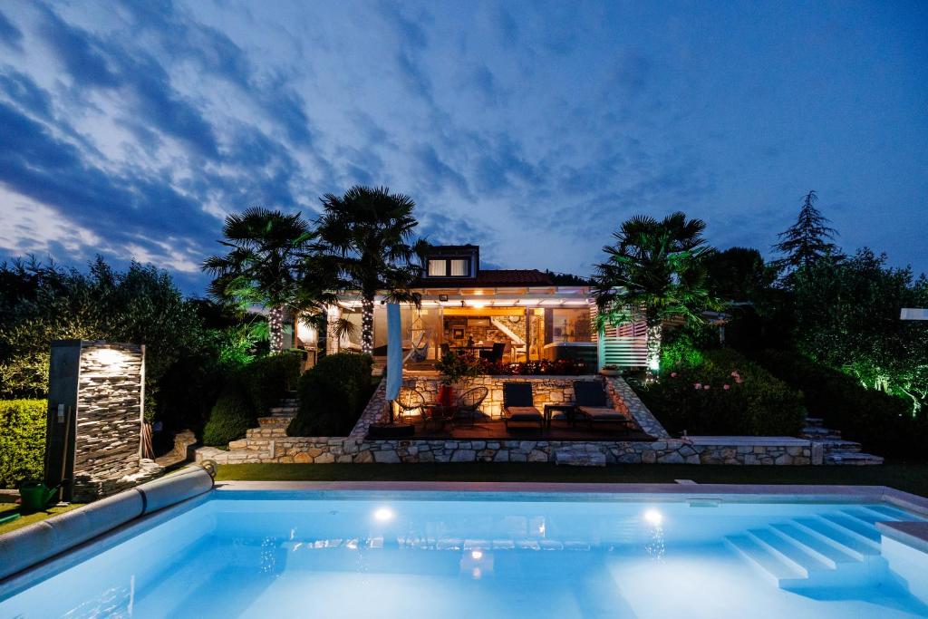 a house with a swimming pool in front of a house at Hacienda Verde in Serres