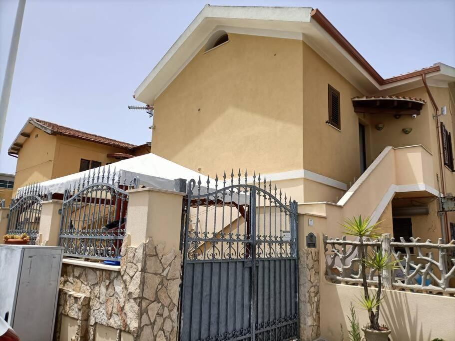 a house with a gate in front of it at Un passo dal mare e dalla città. in Cagliari