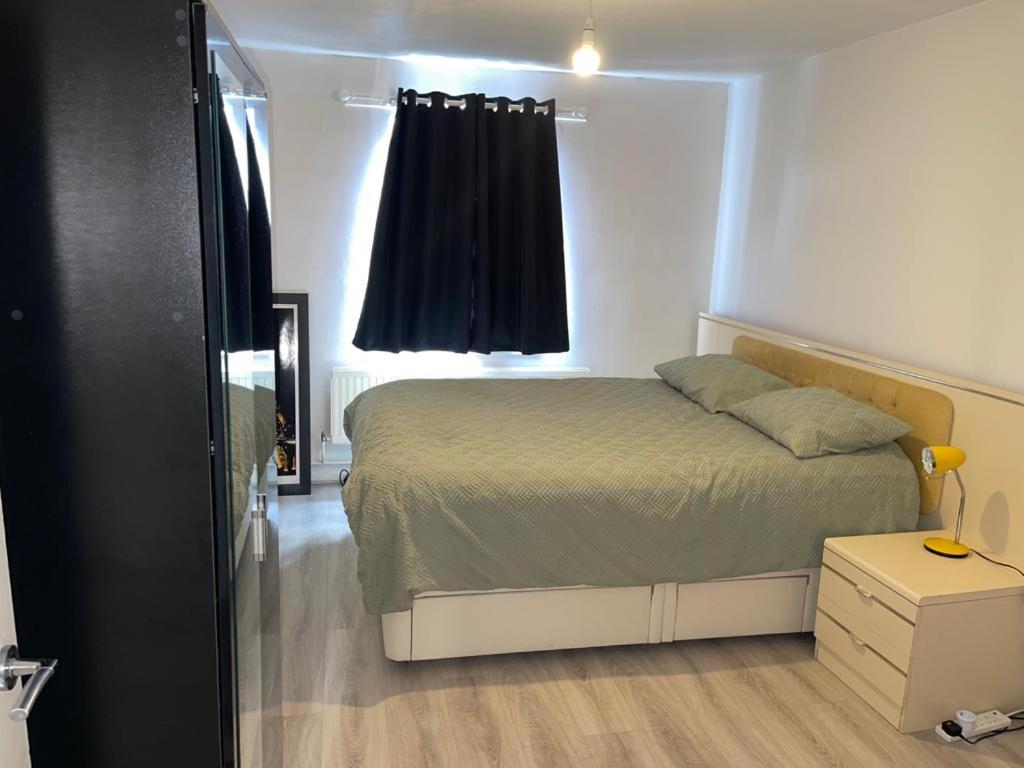 a small bedroom with a bed and a window at room with share bathroom Near train line in London