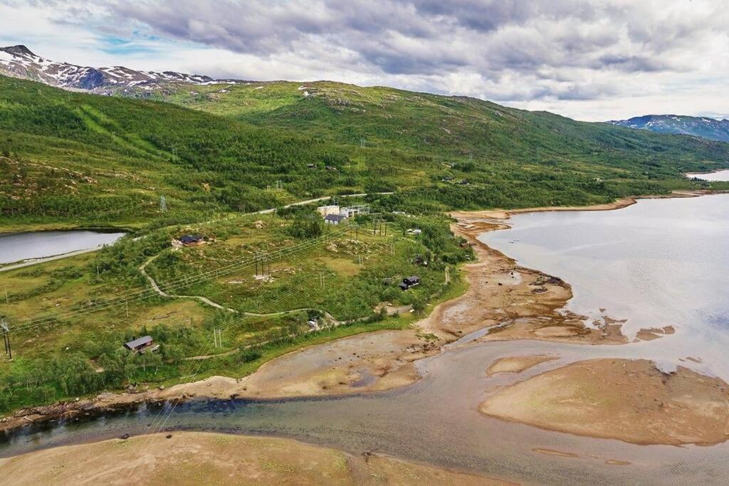 an aerial view of a river and a mountain at Romslig hytte med natur og gode fiskemuligheter! in Lødingen