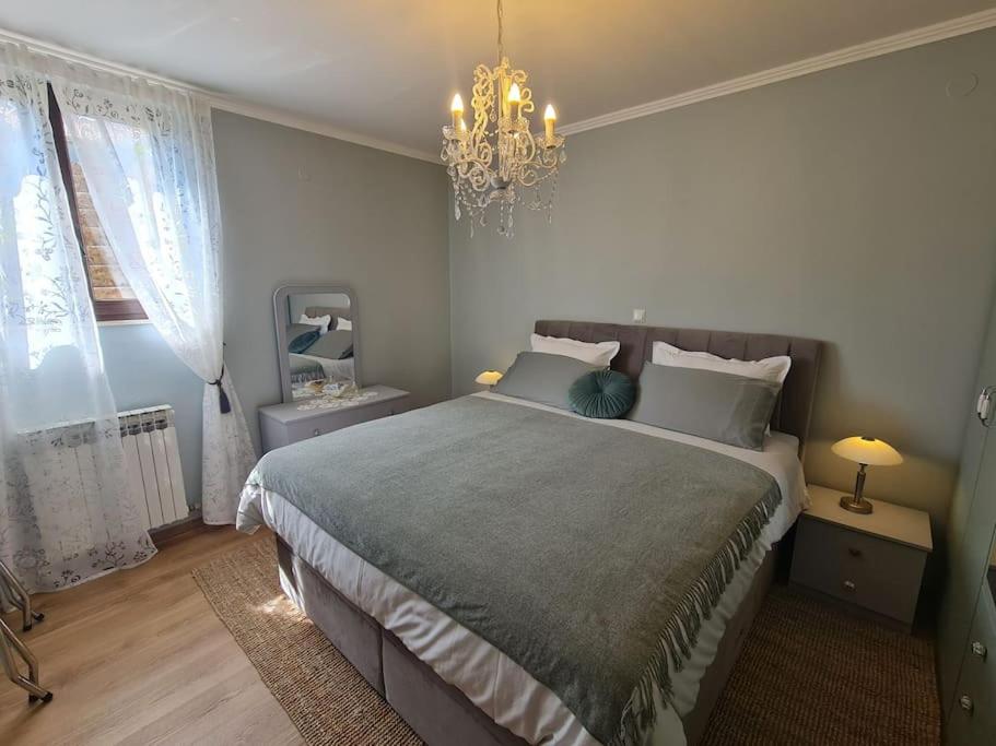 um quarto com uma cama grande e um lustre em Ston apartment Sagittarius em Ston