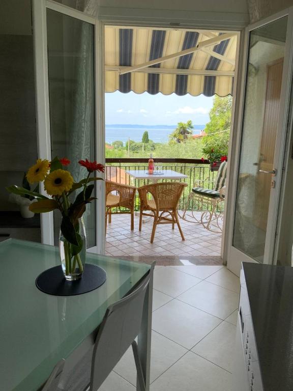a kitchen with a vase of flowers on a table at Elena Apartment - View Lake - Private Garage in Bardolino