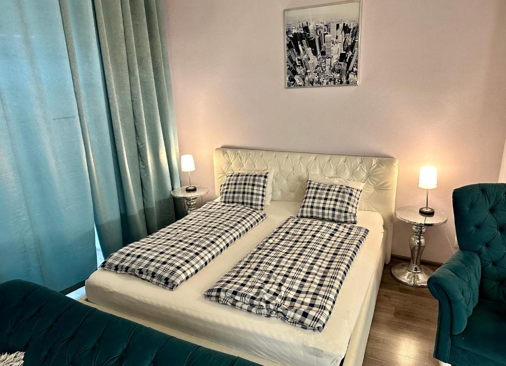 a bedroom with two beds and a couch at Kings main square Apartment in Poprad