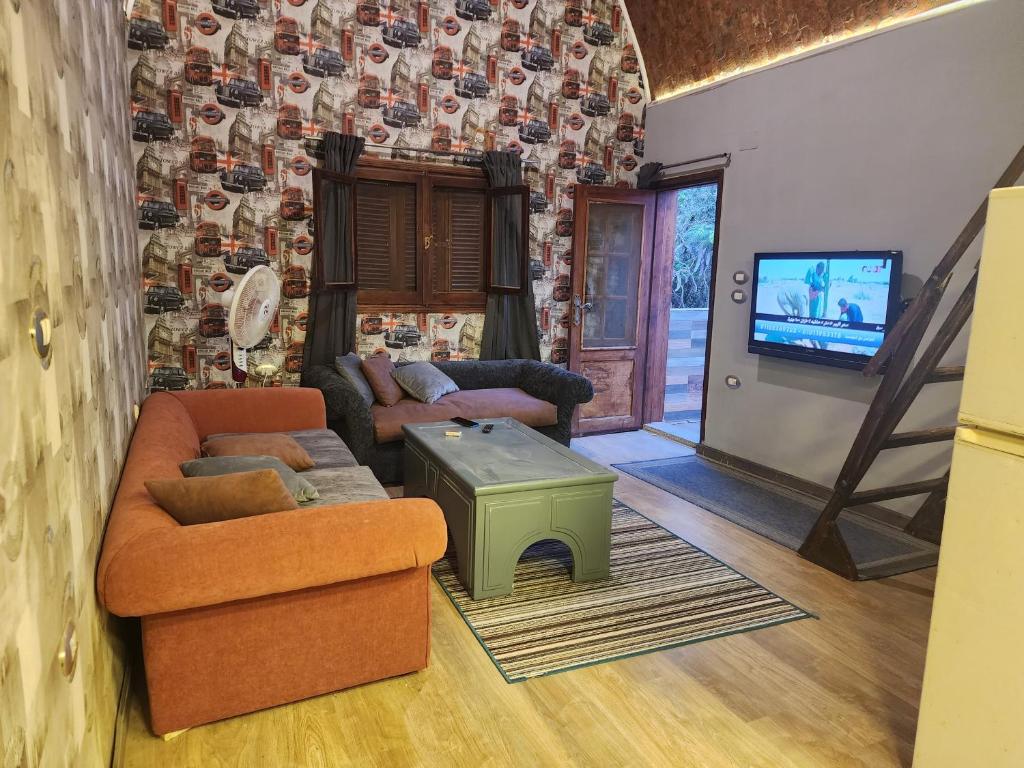 a living room with two couches and a tv at Privat apartment beside mall of egypt in 6th Of October