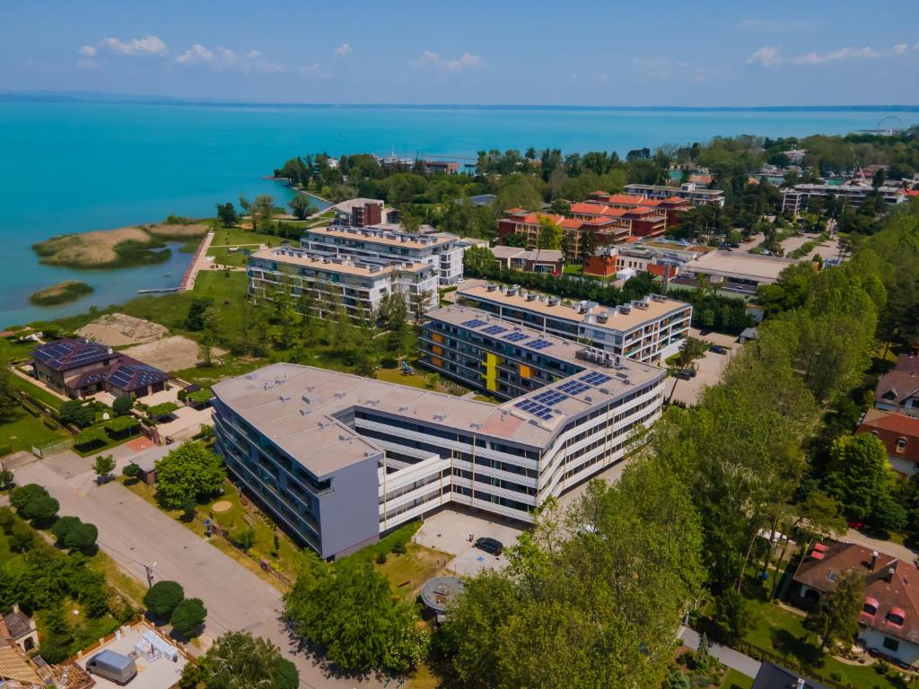 an overhead view of a building with the water in the background at Római Ház 1. Emma Apartman in Siófok