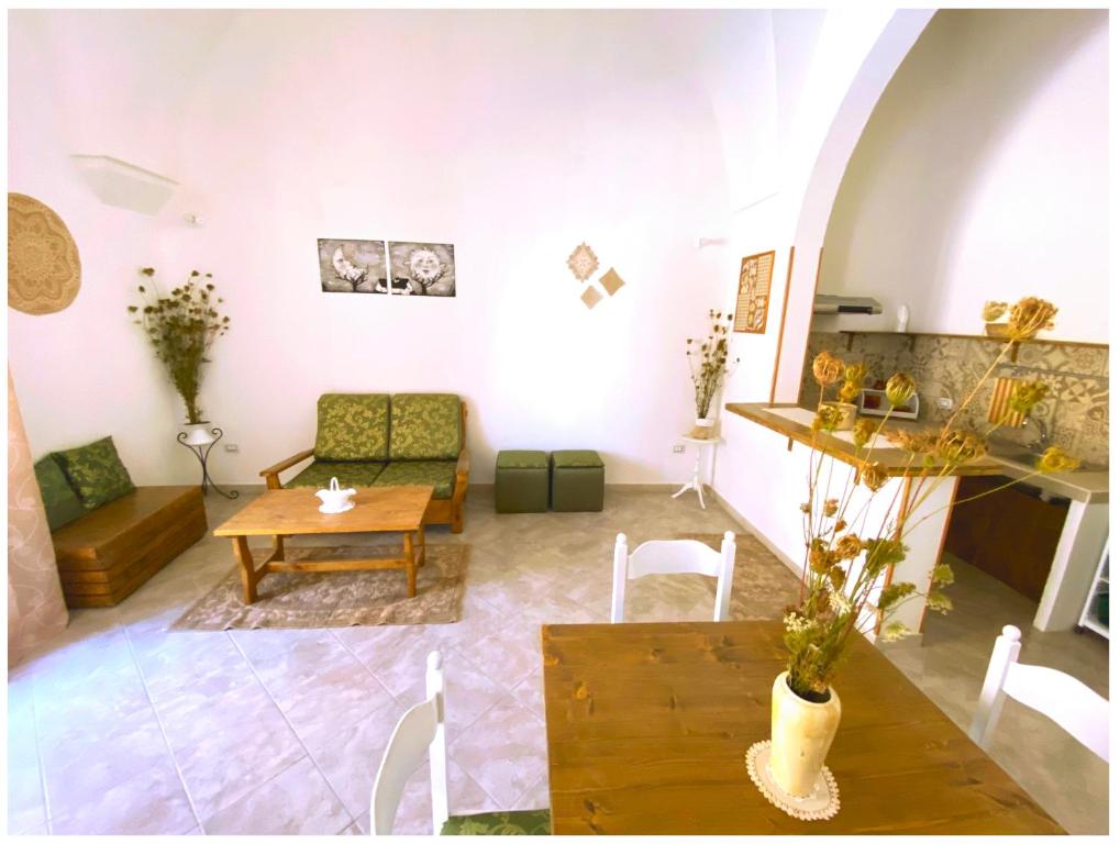 a living room with a table and a couch at Casa Vacanze Patrizia in Botrugno