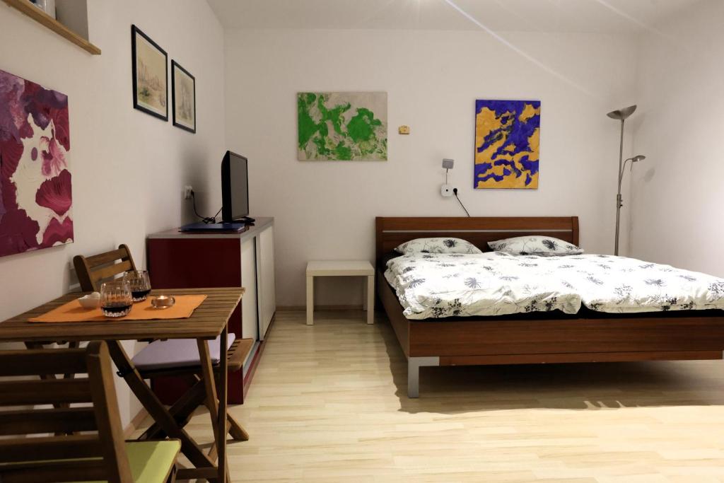 a bedroom with a bed and a desk and a table at Studio Marjetica in Zgornje Gorje