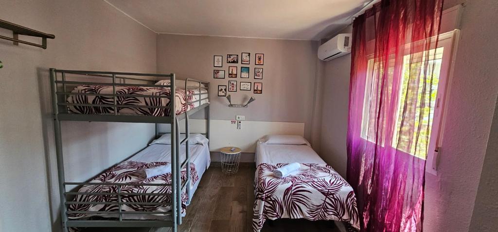 Postel nebo postele na pokoji v ubytování Hostal La Cabaña