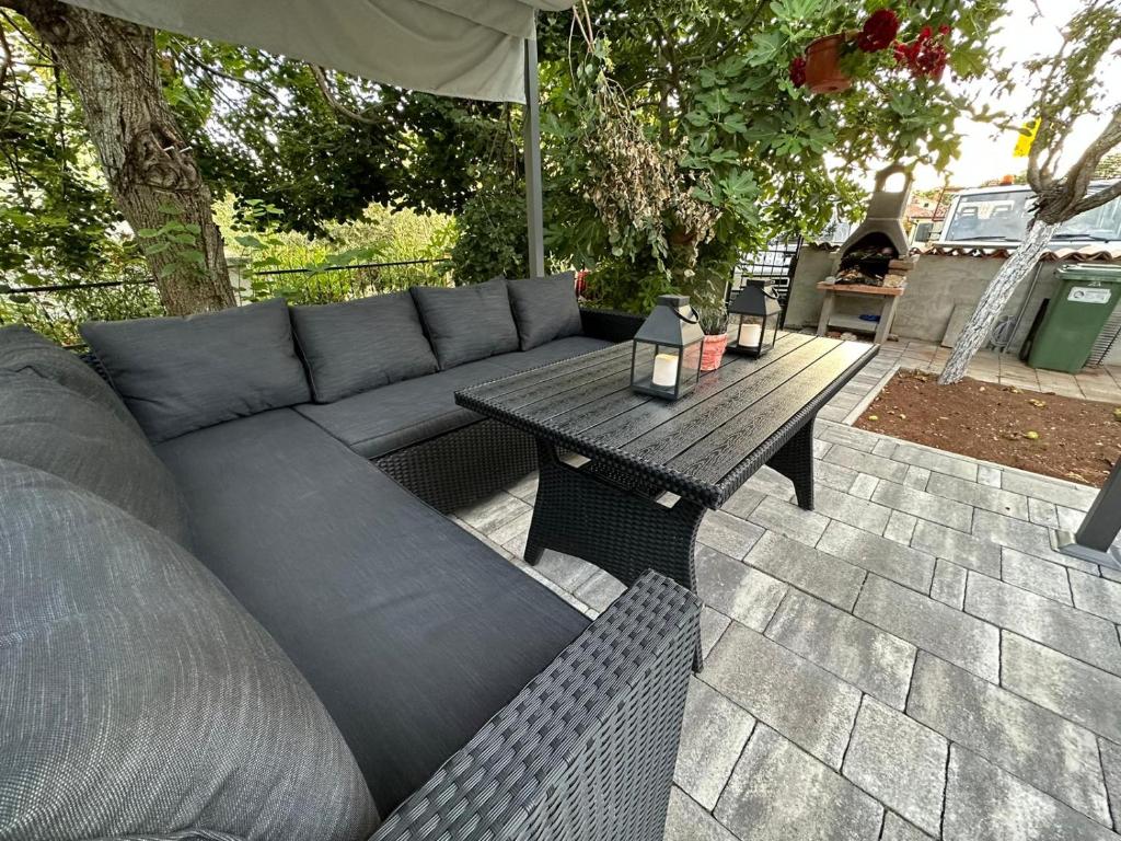 a couch and a table on a patio at Apartments Erenda in Fuškulin