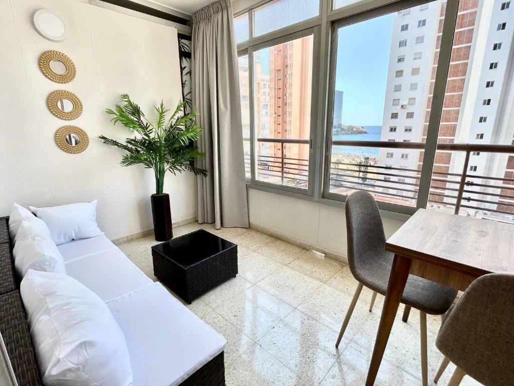 a living room with a white couch and a table at Apartamento Coblanca 6 in Benidorm