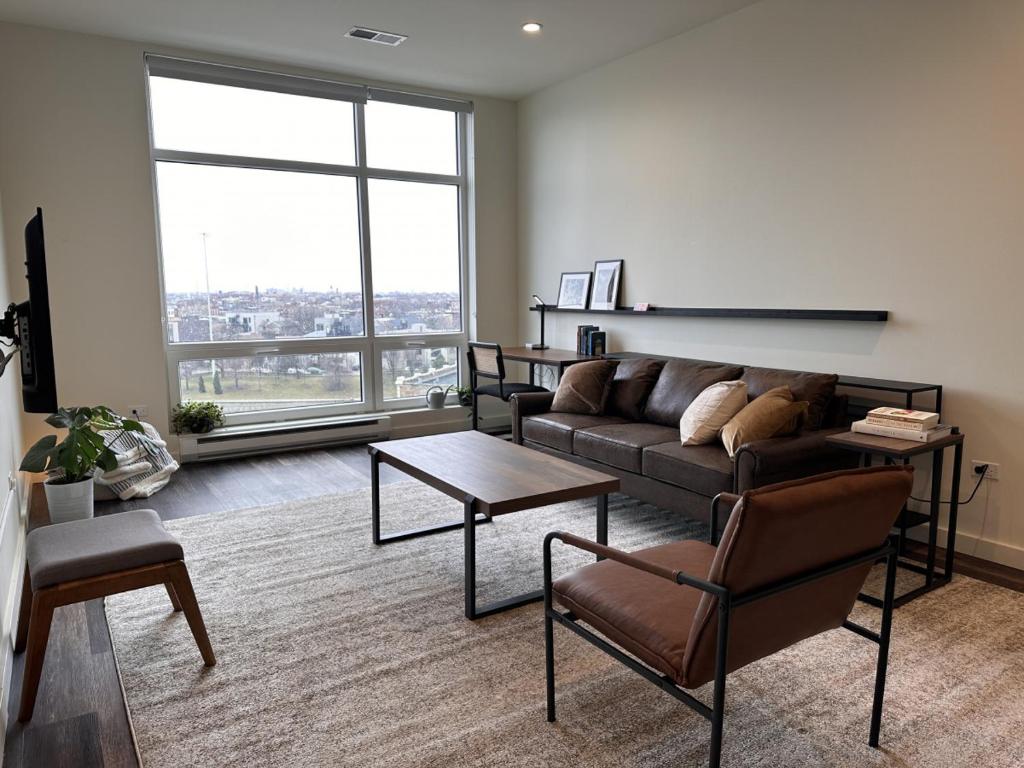 a living room with a couch and a table at Flexhome River West Studio N5 with Gym and Rooftop - READ INFO in Chicago