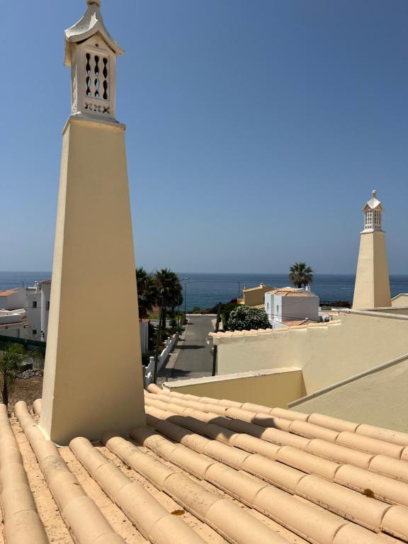 a lighthouse on the roof of a building at Vilas do Mar - Studio in Carvoeiro