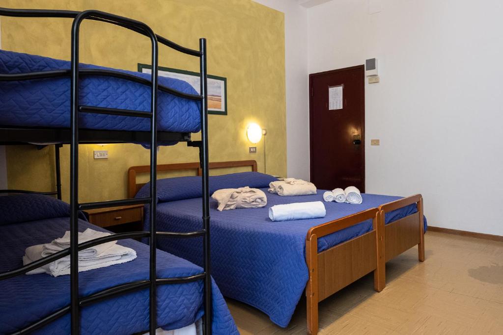 Postel nebo postele na pokoji v ubytování Hotel Pironi