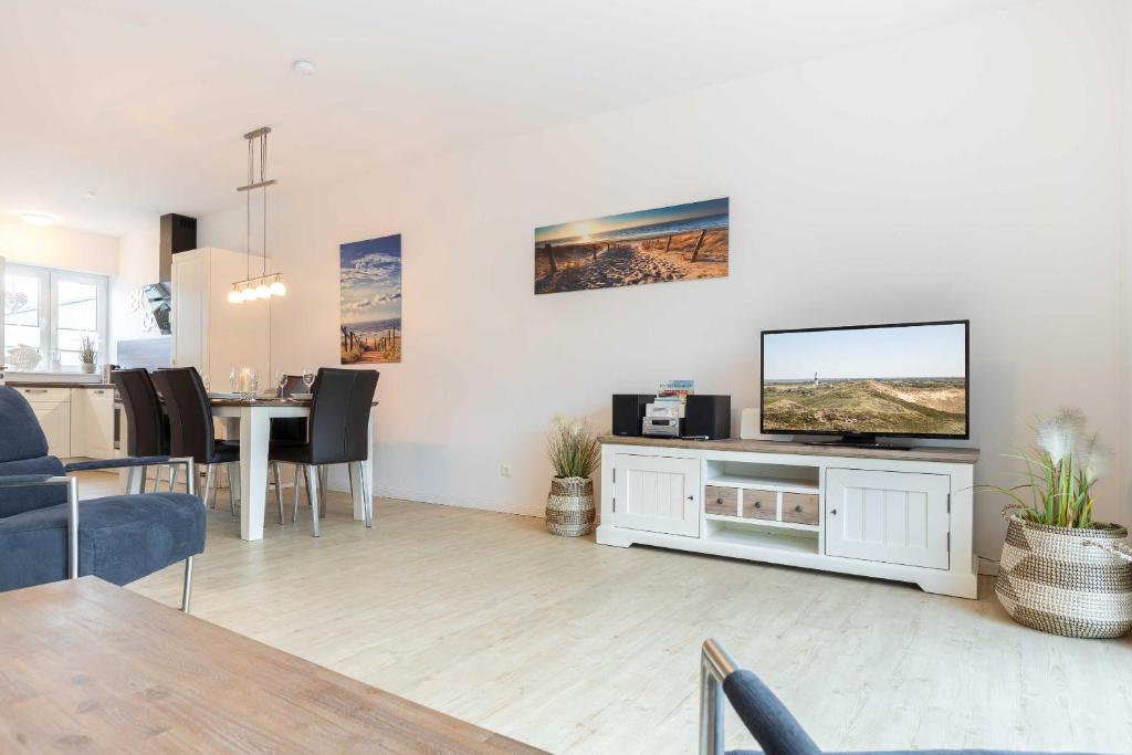 a living room with a television and a dining table at Alte Waescherei _9462_ in List