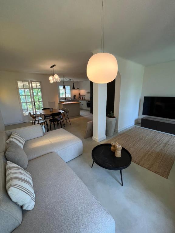 a living room with a couch and a table at Le Verger in Aix-en-Provence