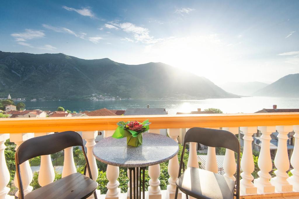 a table on a balcony with a view of the water at Apartment Ena with amazing sea view in Kotor