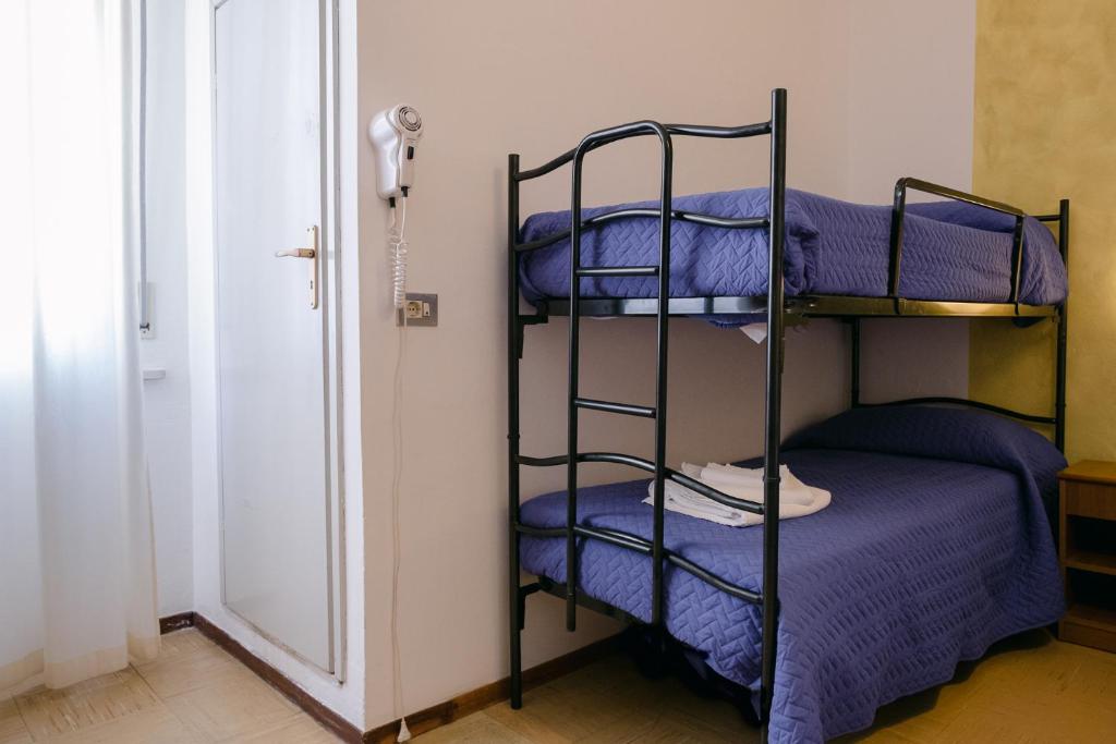 Postel nebo postele na pokoji v ubytování Hotel Pironi