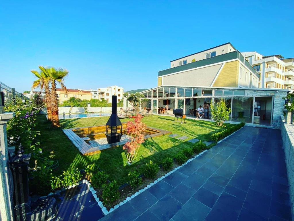 a view of a building with a garden and a house at Royalova Hotel in Yalova