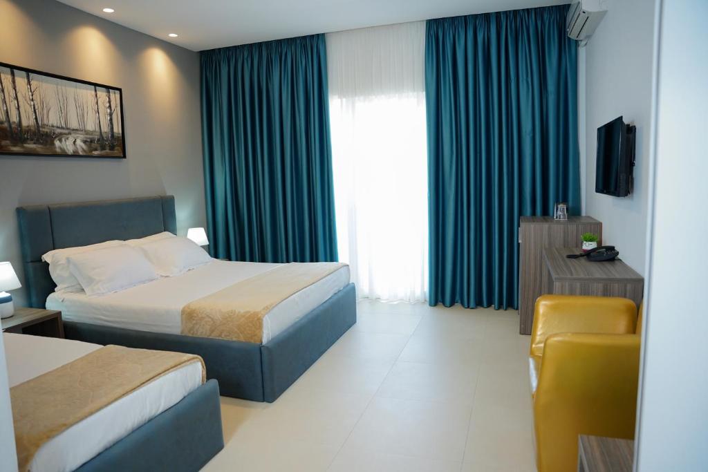 Postel nebo postele na pokoji v ubytování Atrium Deluxe Resort