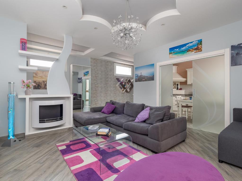 a living room with a couch and a table at Partenope in Sorrento Coast in Piano di Sorrento