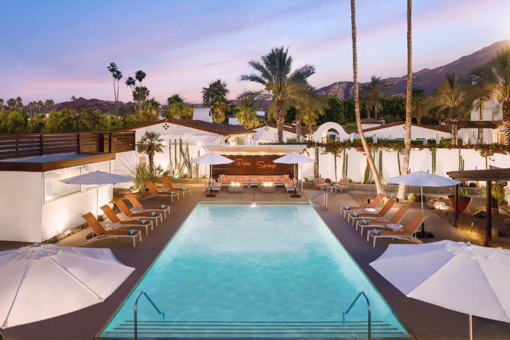 uma imagem de uma piscina de resort com cadeiras e guarda-sóis em Del Marcos Hotel, A Kirkwood Collection Hotel em Palm Springs