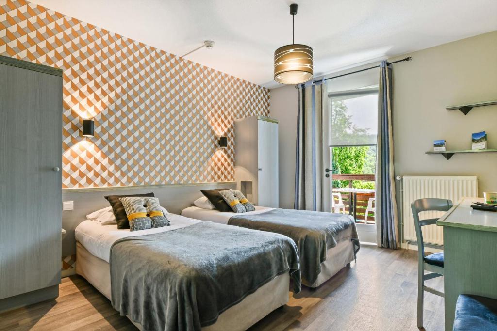 Postel nebo postele na pokoji v ubytování Logis Le Vieux Logis