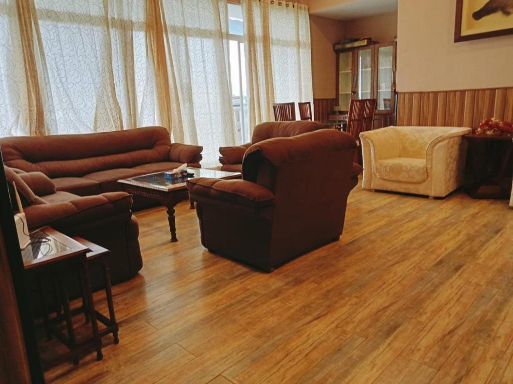 a living room with a couch and chairs and a table at Panorama Luxury House in Nathia Gali