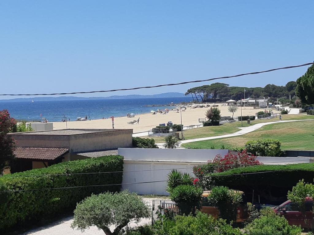 a view of the beach from the balcony of a house at à moins de 100 m de la plage à pied in La Londe-les-Maures