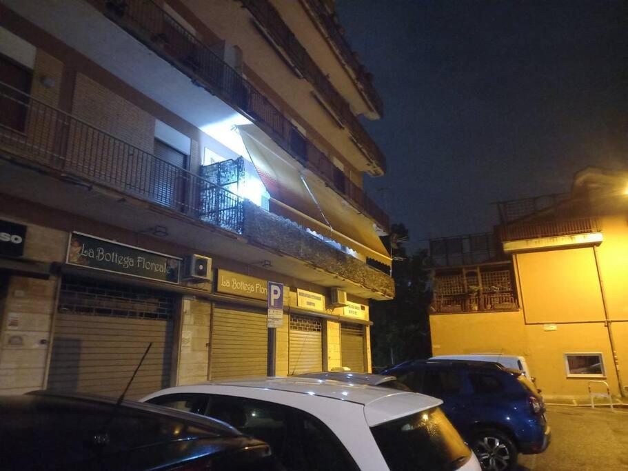 two cars parked in front of a building at night at Premium apartment in Ciampino