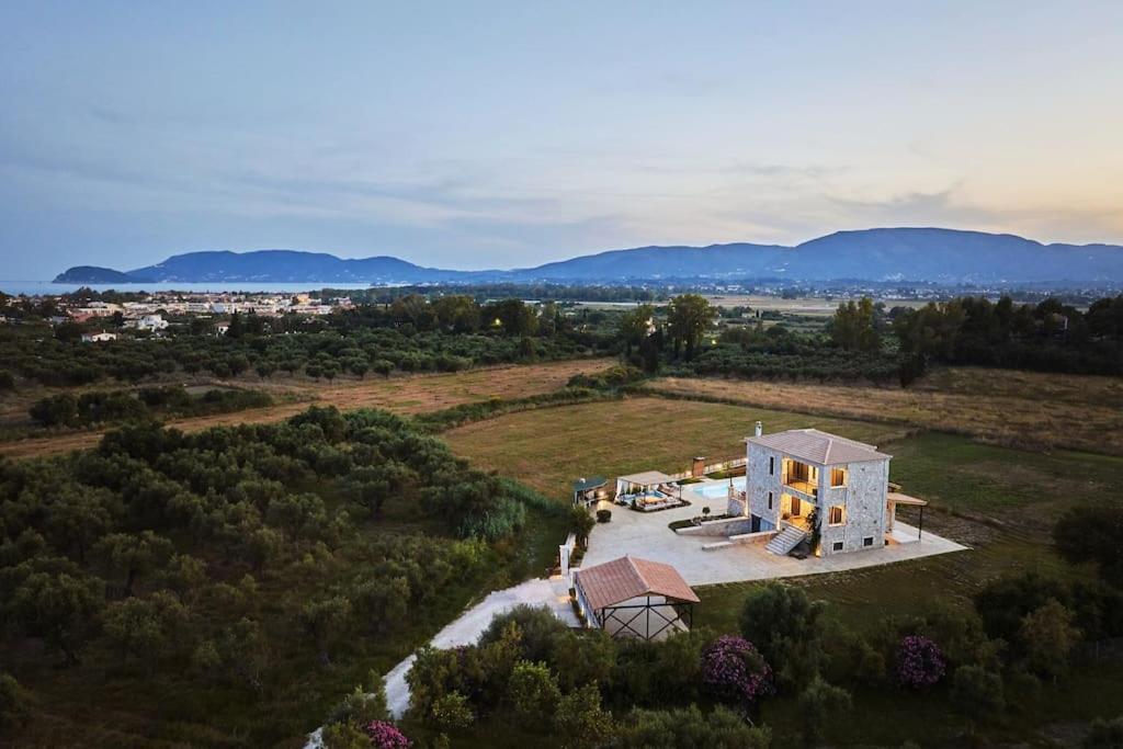an aerial view of a house in a field at Villa Arianna, close to the beach! in Kalamaki