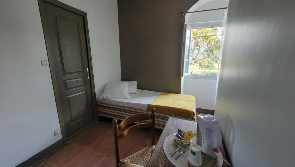 a small room with a small bed and a window at Domaine Ostriconi in Palasca