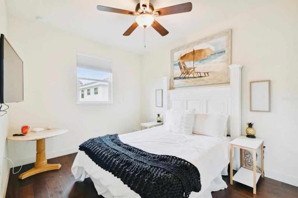 a white bedroom with a bed and a ceiling fan at Beach Downtown Pet-friendly 1 BD @ The Park-633 in Sarasota