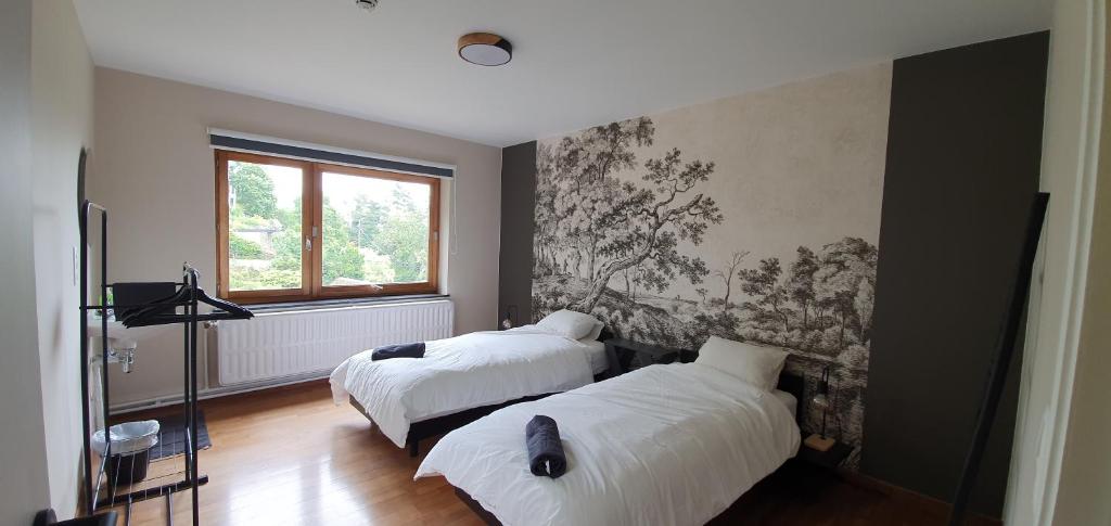 Ein Bett oder Betten in einem Zimmer der Unterkunft D'Hestia - Gîte avec vue imprenable sur Huy