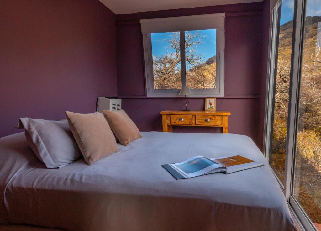 a bedroom with a bed with a book on it at Aizeder - Eco Container in El Chalten