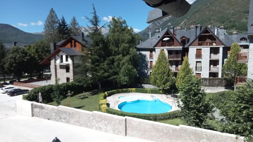 a view from the balcony of a hotel with a swimming pool at EDIFICIO ARDILLAS in Benasque