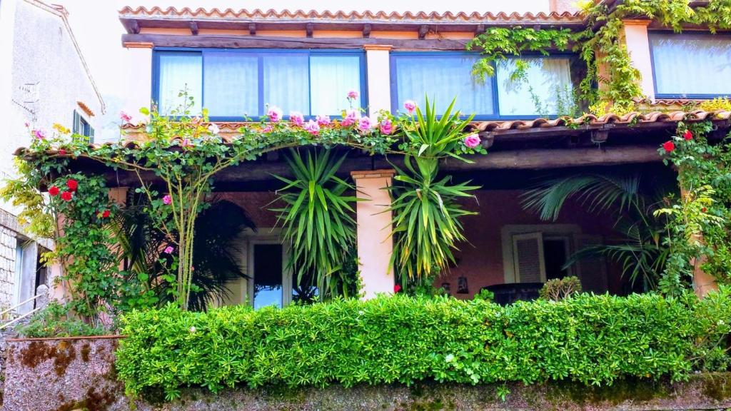 an old building with flowers and plants on it at The Secret Garden Maratea - Casa di Sery in Maratea