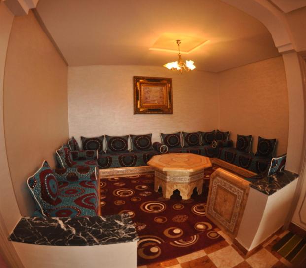 a living room with a couch and a table at Coopérative Village Jbel Moussa du Tourisme in Rcham