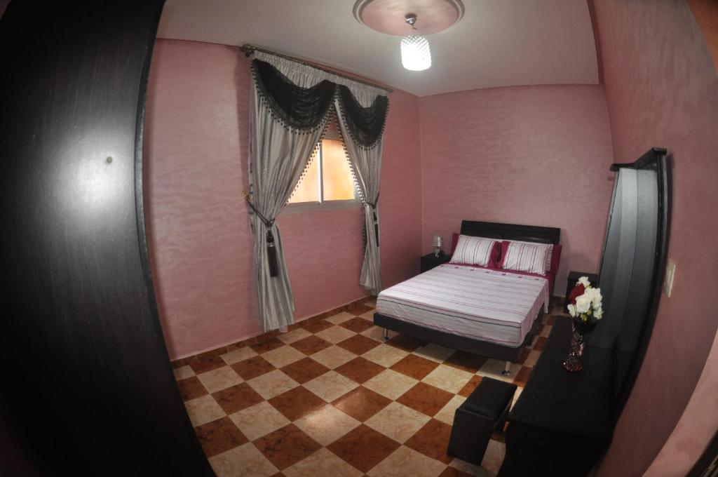 a small bedroom with a bed and a window at Coopérative Village Jbel Moussa du Tourisme in Rcham