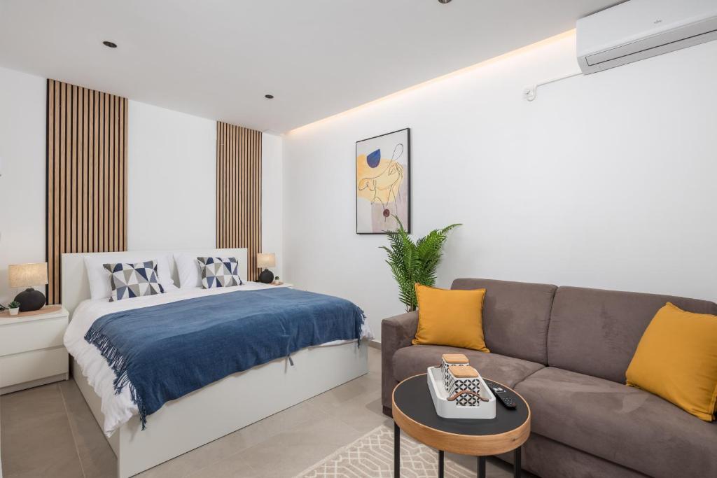 a living room with a bed and a couch at Apartment Salita Calvario in Rijeka