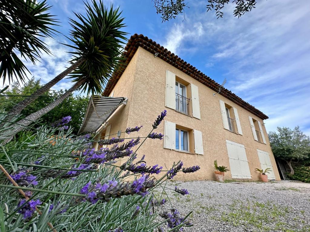 a building with purple flowers in front of it at Villa Marinette in Juan-les-Pins
