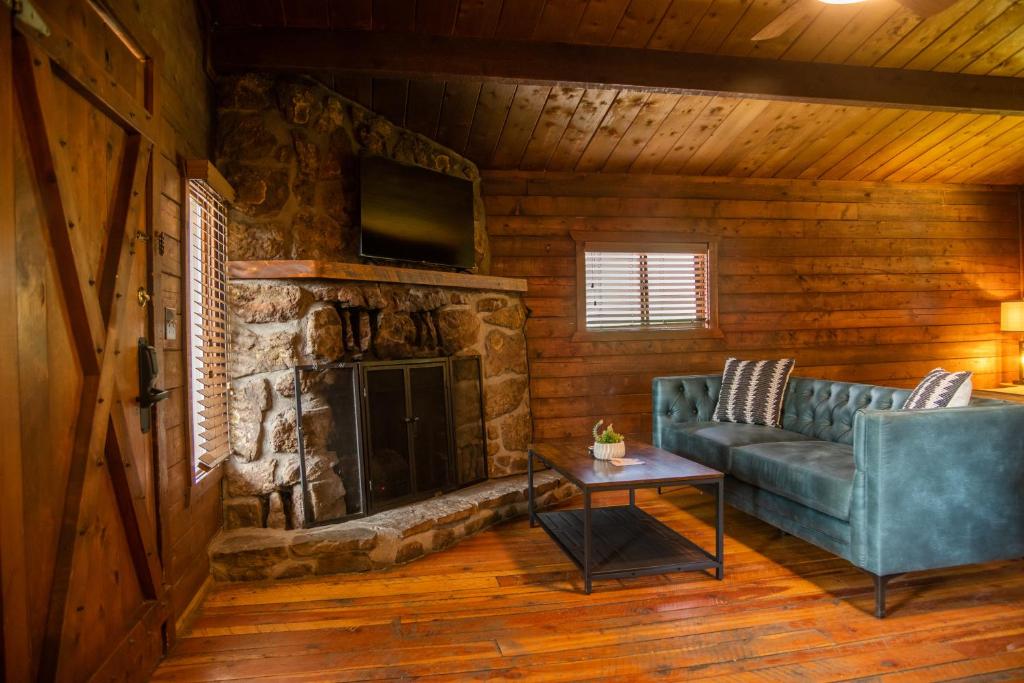 a living room with a couch and a fireplace at High Creek Lodge and Cabins in Pagosa Springs